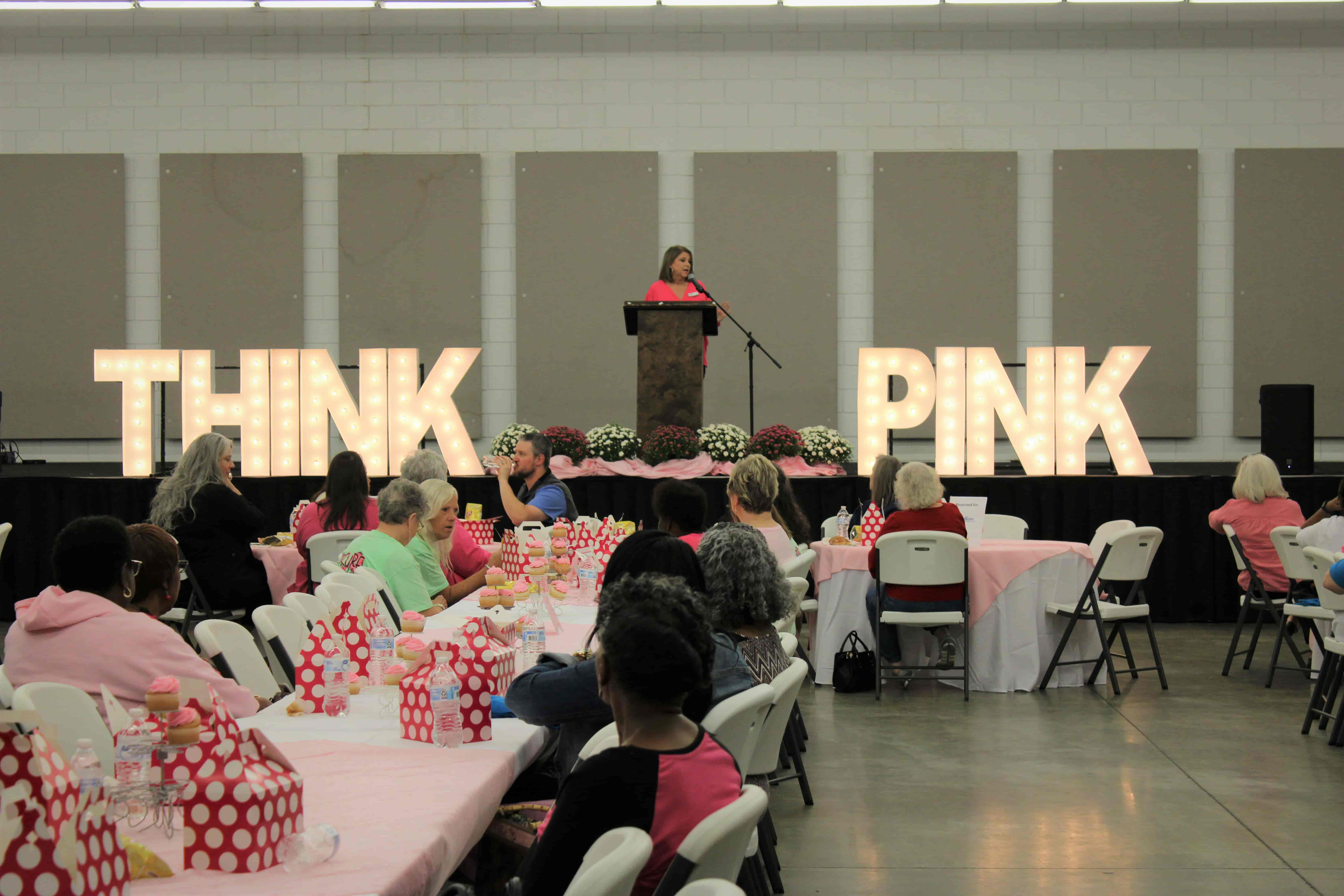 woman at podium on Think Pink stage